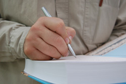 Our editors offer tips that will help you get published. A close-up of a male author signing an autograph on the inside cover of the novel he hopes to get published.