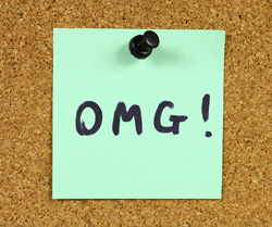 OUr editors explain what acronyms are and how to properly use them in professional and academic writing. A sticky note is pinned to a corkboard. Written on the note is the acronym "OMG".