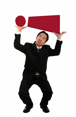 Let our editors help you use exclamation marks effectively. An Asian man in a business suit carrying a large exclamation mark.