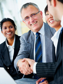Scribendi.com's Case Study Program highlights companies and individuals who have saved time and money by outsourcing their editing and proofreading services. Four colleagues are shaking hands after making a deal to outsource their editing and proofreading needs.
