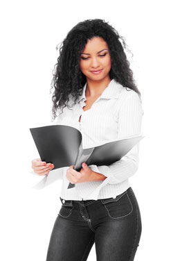 Our editors explain how to write a functional resume. A young woman with long, curly hair is holding a functional resume while standing.