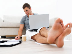 Our editors explain what a prologue is and when to use it. A young man sits on his living room floor with a laptop and papers surrounding him; he is deciding if he should write a prologue for his book.