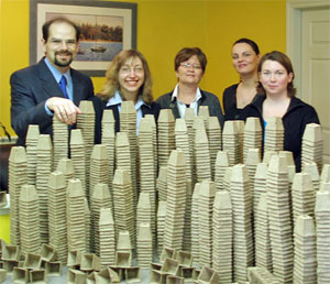 Five members of the Scribendi.com office staff stand with 10,000 peat pots that were donated to the Municipality of Chatham-Kent.