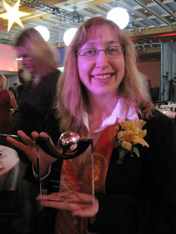 President, Chandra Clarke, accepts Scribendi.com's Ontario Global Traders Award - Marketing Expansion - Silver. Scribendi.com President, Chandra Clarke, is holding the Ontario Business Achievement Award.