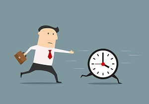 A businessman chases a clock.