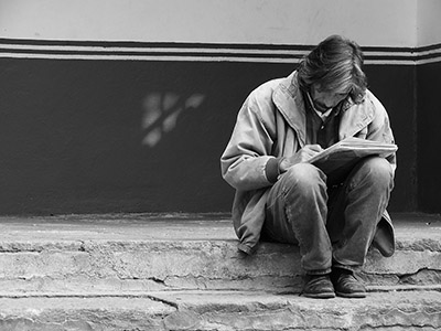 An artist sketches in a notebook.