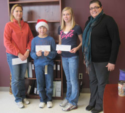 Scribendi.com donated funds to the McFadden Fundraiser at Indian Creek Road Public School. Two adults and two children stand with cheques donated by Scribendi.com to the McFadden fundraiser.