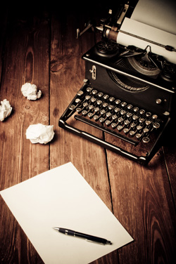 A typewriter with crumbled paper.