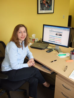 Scribendi.com President Chandra Clarke is sitting at her computer desk. She is in an interview with WorkAtHomeWoman.com.