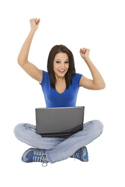 Scribendi.com's new website launch in 2005 met the needs and wants of clients. A young woman is sitting on the floor with her labtop. Her arms are up in the air and she is smiling because of Scribendi.com's new website launch.